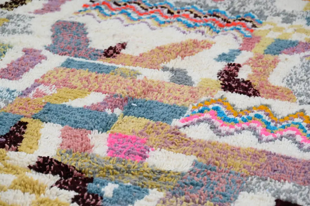 Colorful textured decorbites™ handmade moroccan azilal rug with pastel patchwork patterns in pinks blues yellows and purples
