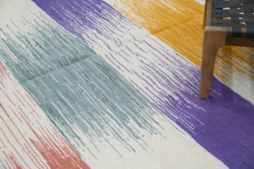 Colorful handmade moroccan azilal rug with bold diagonal stripes in purple yellow teal and coral 302x197cm