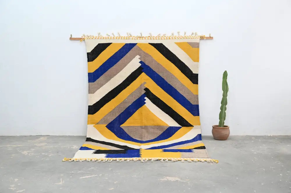 Vibrant handmade moroccan azilal rug with bold yellow blue black and beige stripes in a geometric abstract pattern