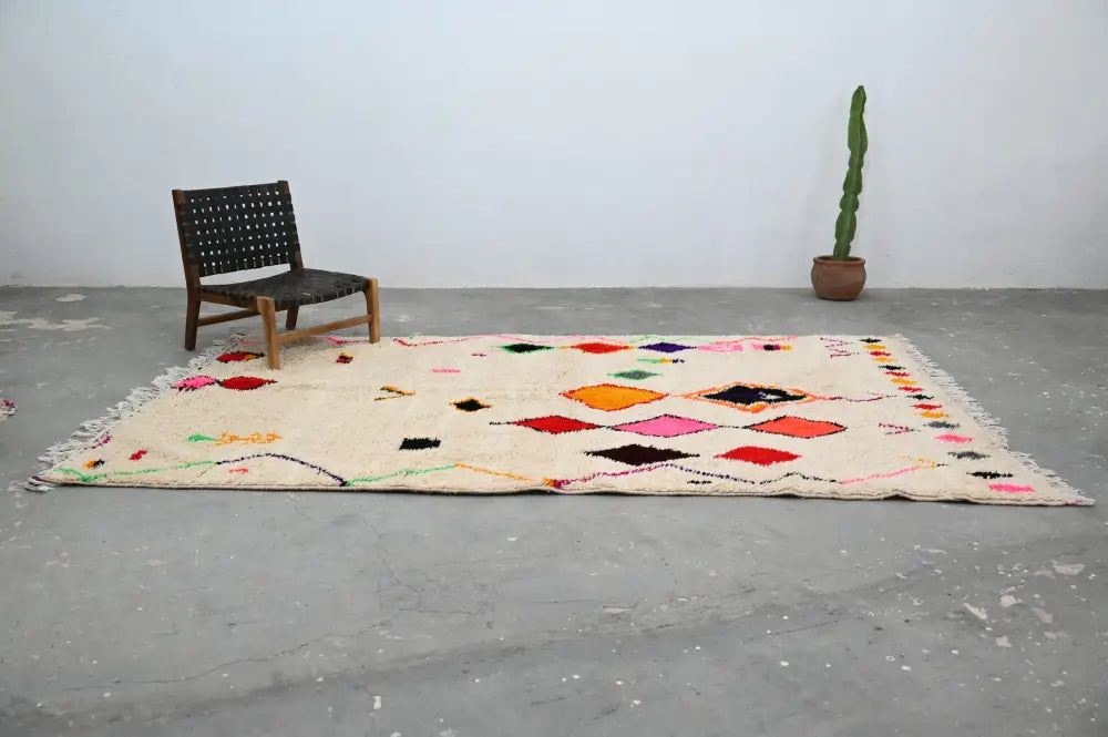Cream-colored handmade moroccan azilal rug with vibrant pink orange black and green geometric patterns 309x195cm