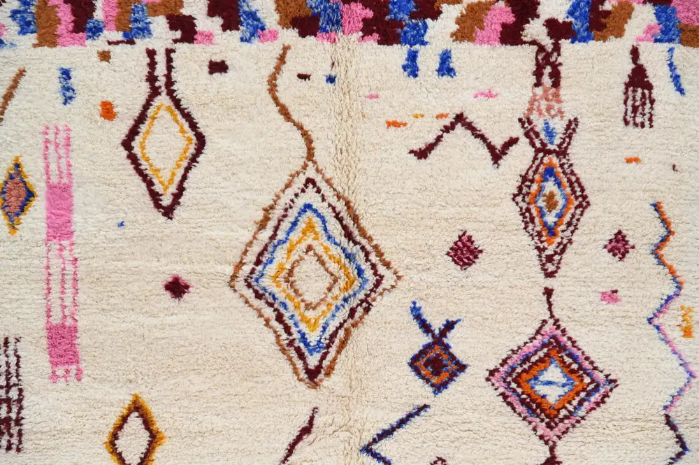 Cream-colored handmade moroccan azilal rug with vibrant pink blue yellow and brown geometric patterns 309x207cm
