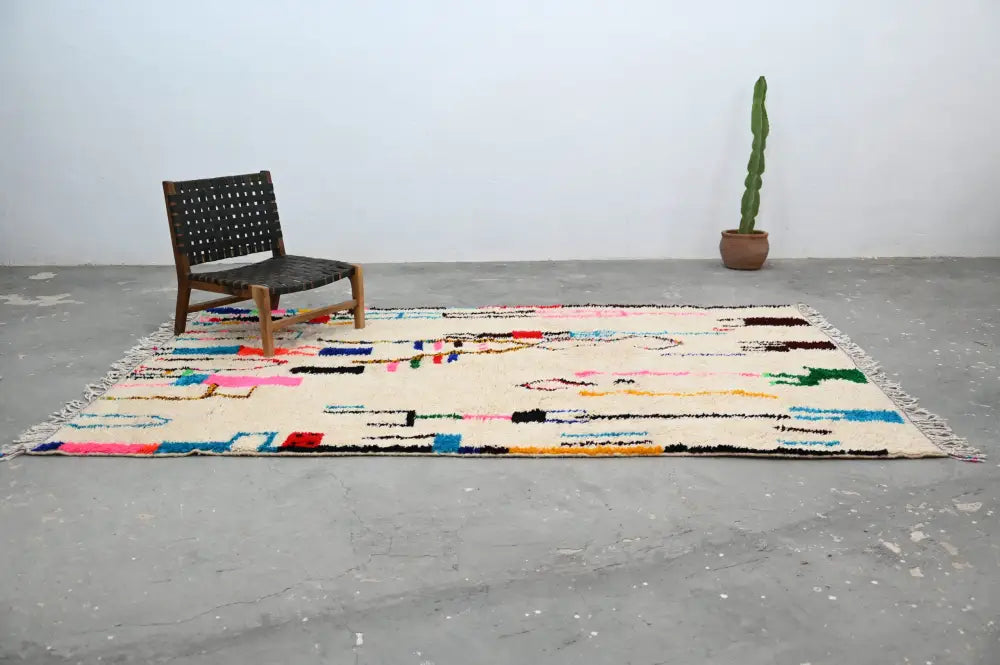 Beige moroccan azilal rug with colorful geometric patterns and fringed edges by decorbites handmade 313x194cm