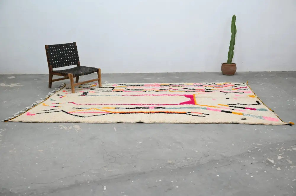 Beige handmade moroccan azilal rug with vibrant pink black yellow and teal geometric patterns 315x194 cm