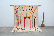 Beige handmade moroccan azilal rug with vibrant abstract geometric patterns in pink black orange and teal 315x194 cm