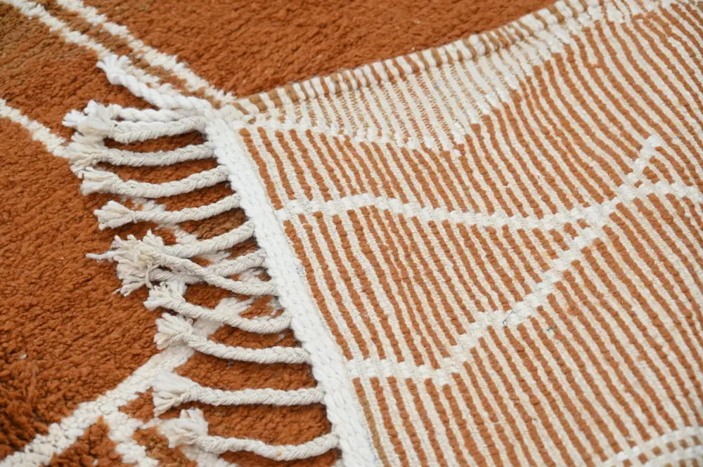 A cozy orange and white woven traditional azilal rug with geometric pattern and fringed edges, 328x197cm by DecorBites™