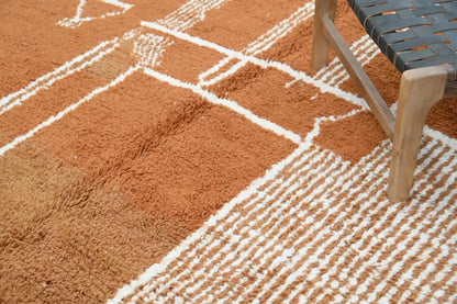 A plush terracotta orange decorbites™ handmade traditional azilal rug with white geometric woven lines 328x197cm