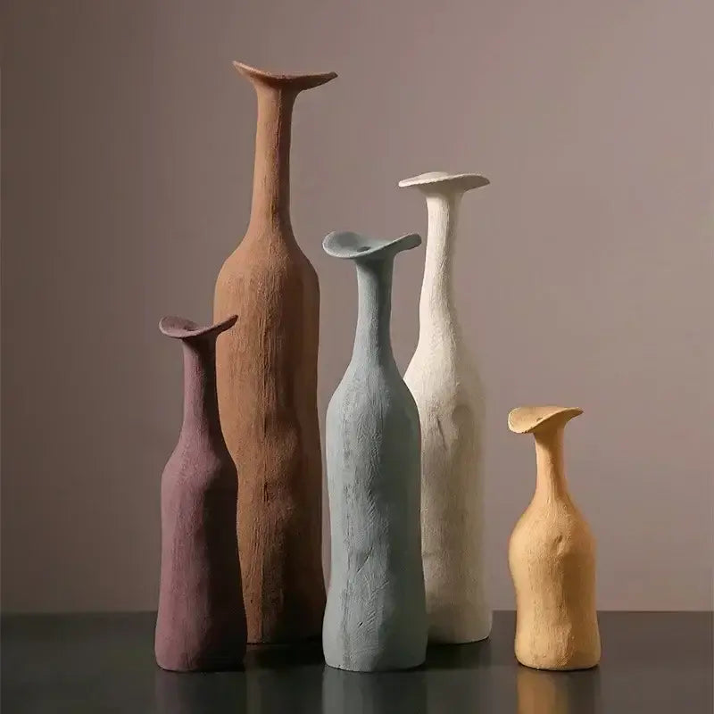 A set of five handcrafted ceramic flower vases in earthy tones with unique sculpted shapes for luxury home decor