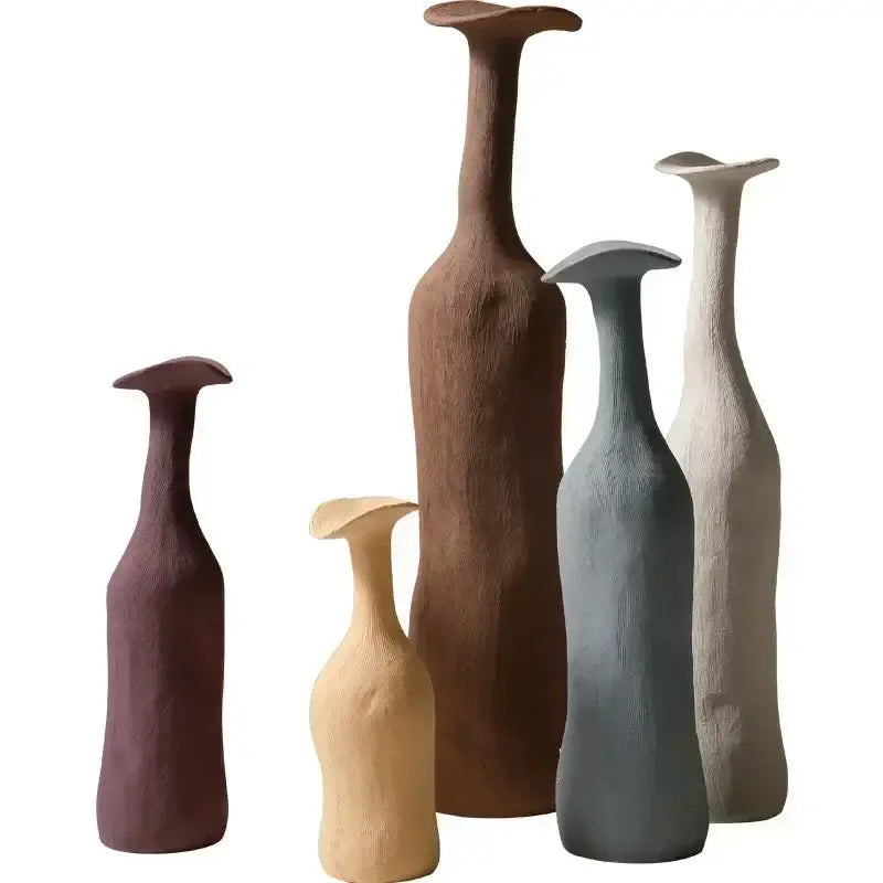 Set of five handmade nordic ceramic flower vases in earthy tones with textured organic shapes and flared tops