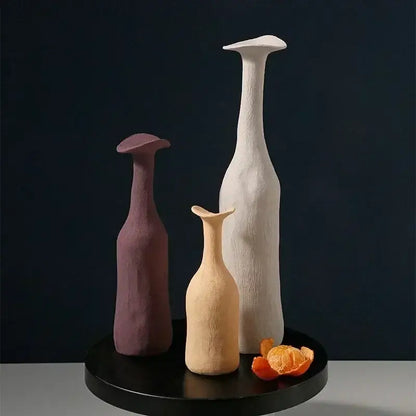 DecorBites™ handmade nordic ceramic flower vases in muted purple beige and white on a black circular base