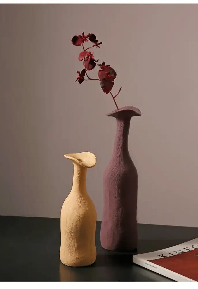 Two ceramic flower vases in warm beige and muted purple with textured surface and flared necks by decorbites luxury home