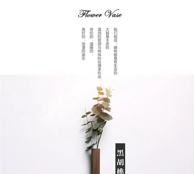 Black handmade nordic solid wood wall vase with sleek cylindrical design holding dried eucalyptus branches