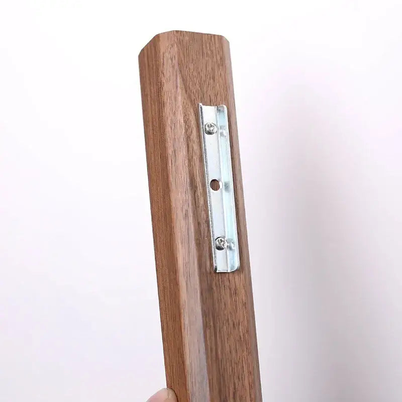 Brown wooden picture frame bracket with silver metal mounting plate on the backside of handmade nordic solid wood wall vase