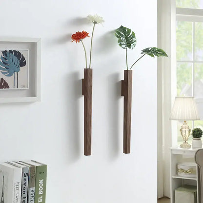 Two sleek dark brown handmade nordic solid wood wall vases by DecorBites for minimalist plant display