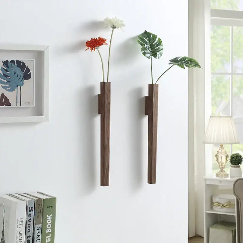 Two sleek dark brown handmade nordic solid wood wall vases by DecorBites for minimalist plant display