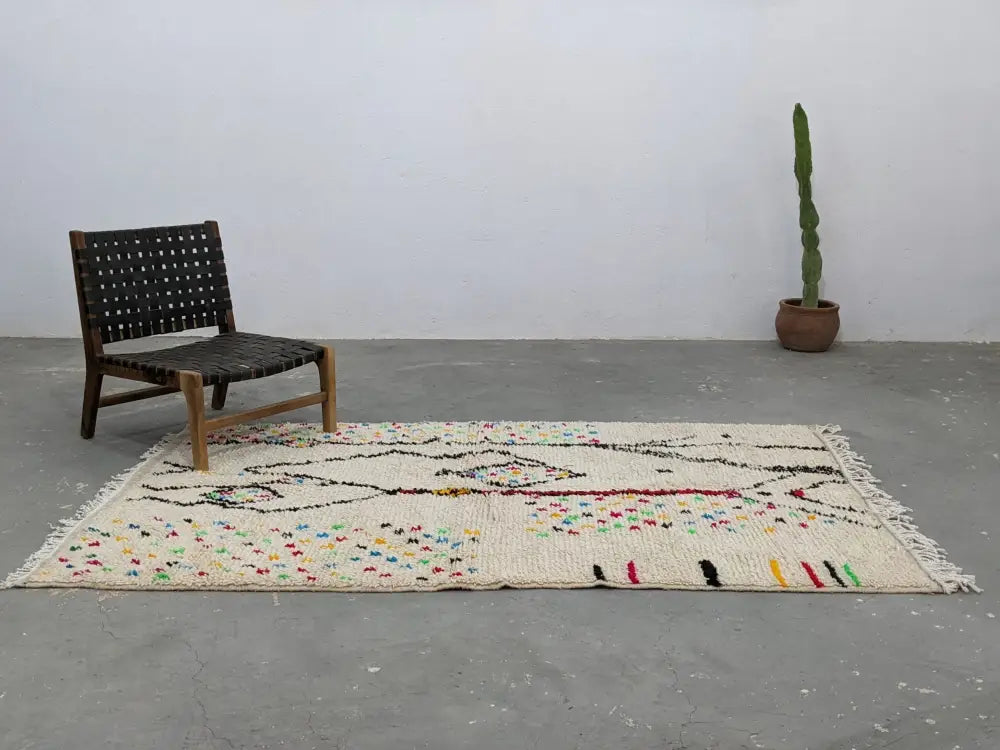 Beige handwoven moroccan azilal rug with colorful geometric patterns and fringed edges 234x147 cm by decorbites