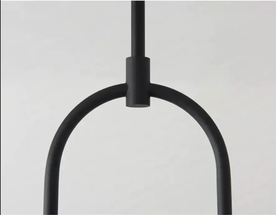 Black matte metal pendant hanging light with minimalist u-shaped design offering versatile lighting options by decorbites