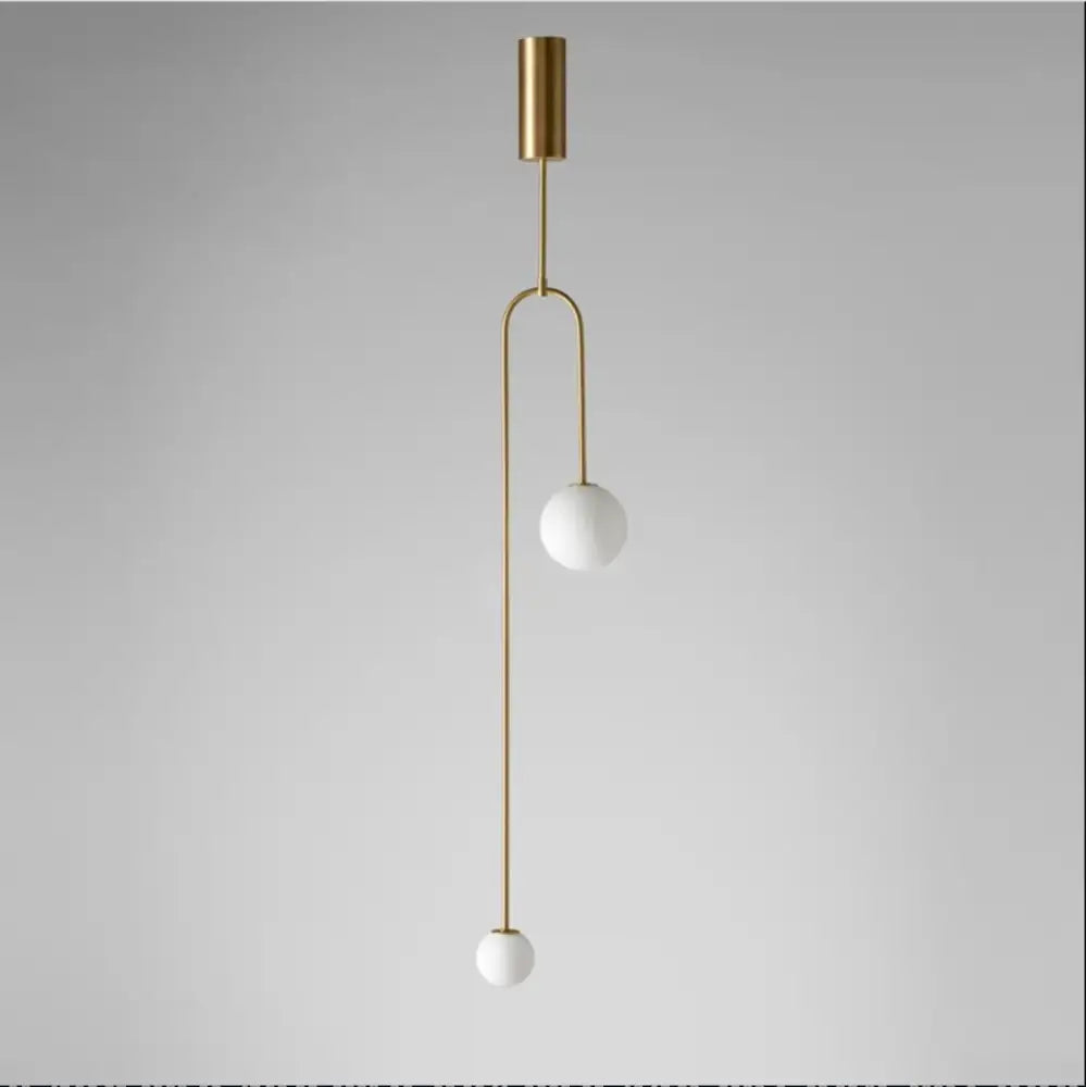 Decorbites™ hanging lights featuring gold finishes with two white glass spheres on slender curved metal arms provide versatile lighting options
