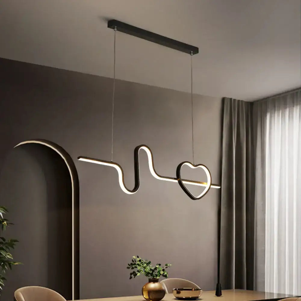 Modern black metal LED line island pendant light fixture with a heart-shaped design for dining room decor