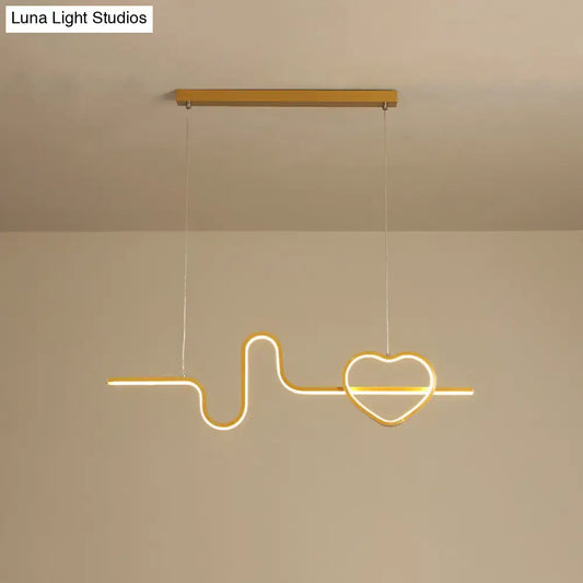 Gold-toned metal led pendant light shaped like an electrocardiogram line ending in a heart for dining room use