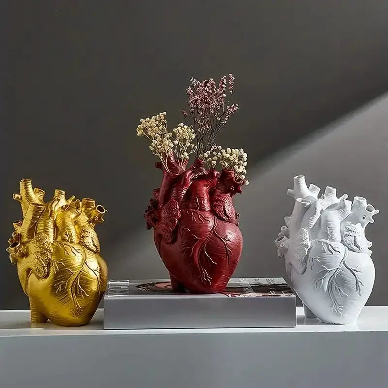 Red heart shape resin vase by DecorBites™ holding dried flowers with anatomically detailed design