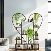 Black metal heart shaped 6 tier plant stand with wooden shelves and planters by DecorBites™