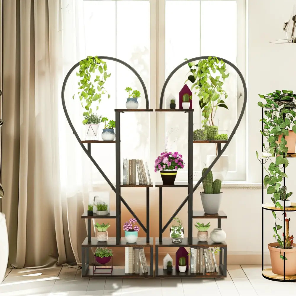 DecorBites heart shaped 6-tier plant stand with dark brown wood shelves and black metal frame holding plants and books