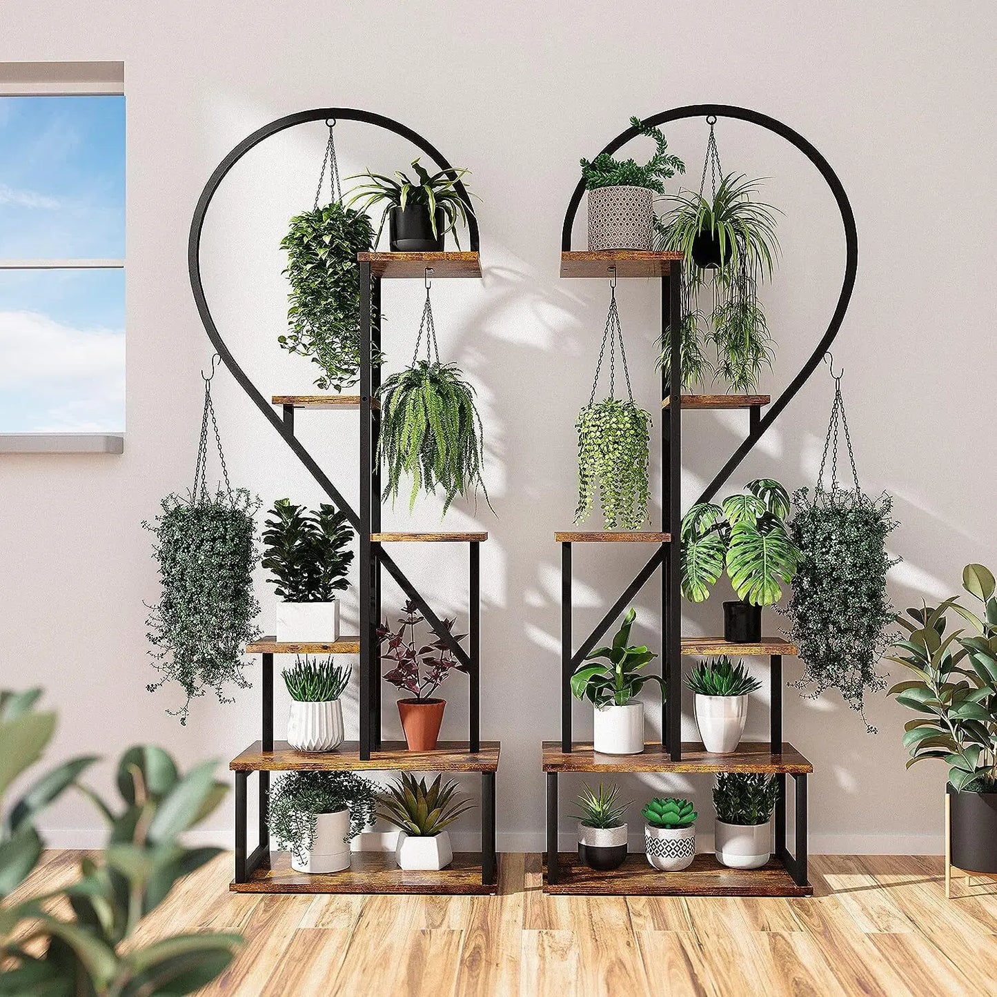 Rustic wooden plant stand with black metal heart shape frames and hooks holding assorted potted plants by decorbites