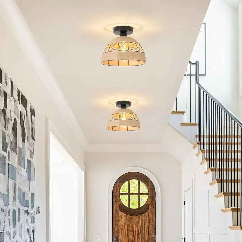 Two beige geometrically patterned glass pendant lights with black fixtures in a DecorBites hemp rope ceiling light design