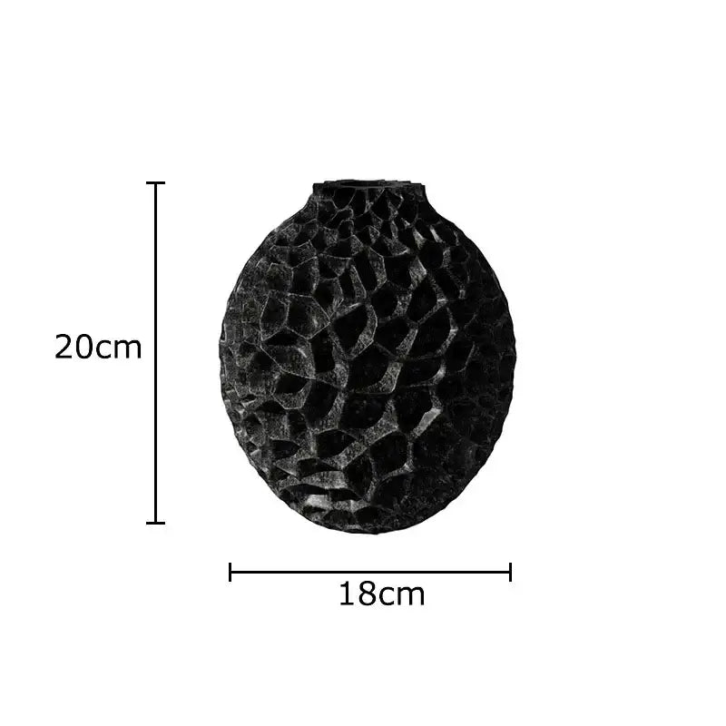 Black textured ceramic honeycomb vase with rounded faceted surface and narrower top by decorbites for office decor