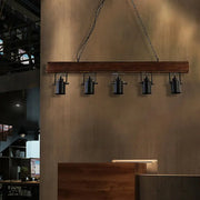 DecorBites™ industrial black metal island light fixture with wooden beam and five spotlights hanging by chain cord