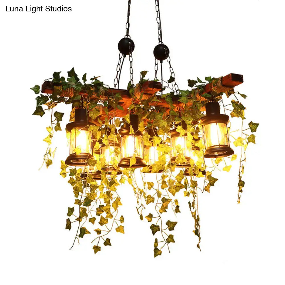 Rustic wooden industrial black metal lantern island light with 8 hanging lanterns and artificial ivy vines by DecorBites