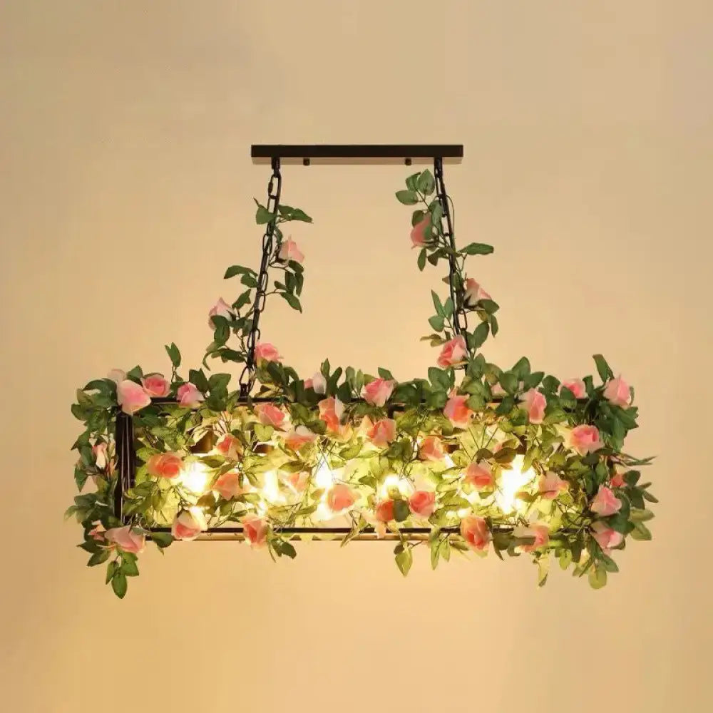 Rectangular black metal cage island pendant light with pink rose plant decoration for rustic restaurant lighting