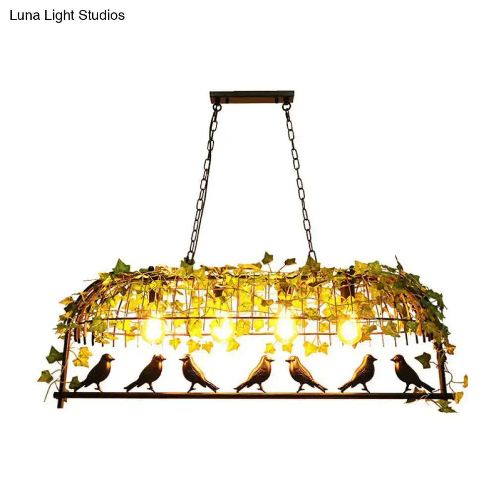 Wrought iron bird-themed pendant light with golden finish and green imitation leaf accents for dining room decor