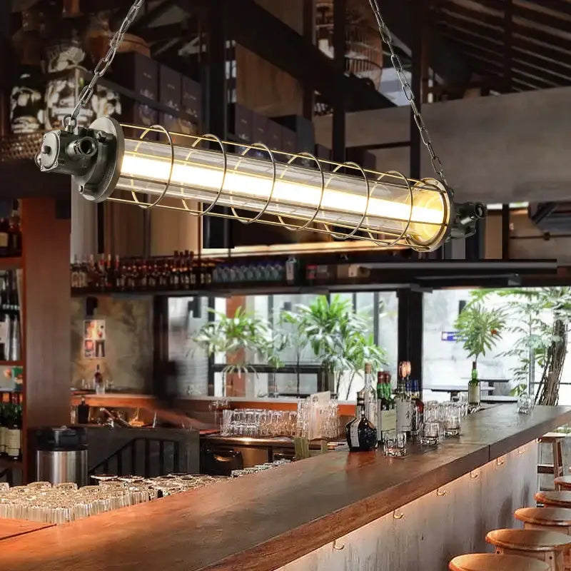 Decorbites industrial chandelier with a long glass tube encased in a metal cage suspended by chains for cafe lofts