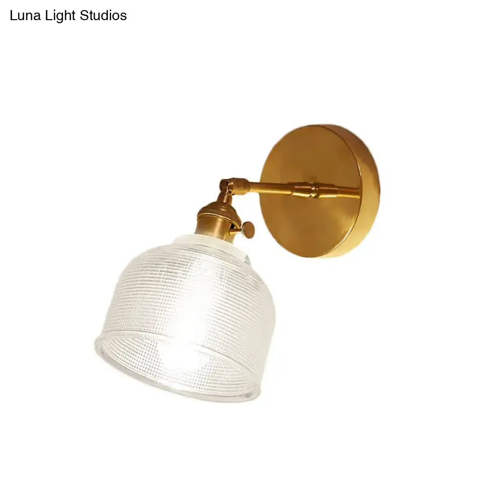 Gold-finished industrial brass wall sconce with a clear ribbed glass dome wall shade for bedroom lighting