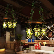 Rustic wooden beam pendant lights with clear glass cylindrical heads and hanging green vines for restaurant island light decor