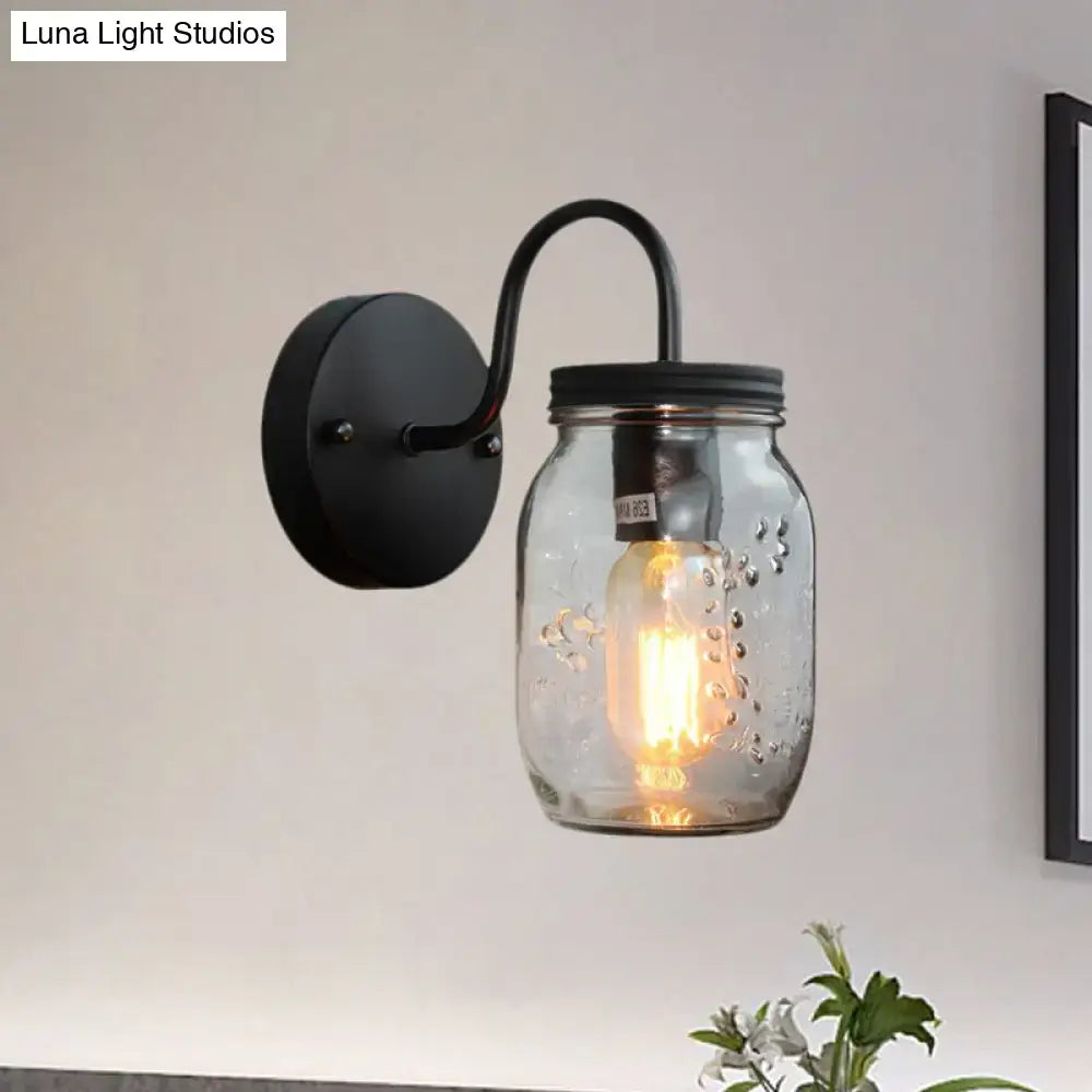 Black metal wall lamp with clear glass mason jar featuring textured bubbles and black jar shade for bedroom lighting