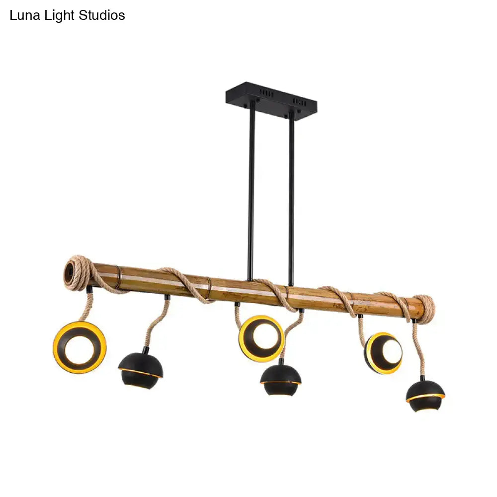 Decorbites™ industrial linear chandelier with natural bamboo rod, black iron pendant, rope accents, and gold-rimmed black dome lamps