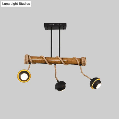 Decorbites industrial linear chandelier with bamboo tube and rope featuring black iron rods and adjustable spotlights in black and gold
