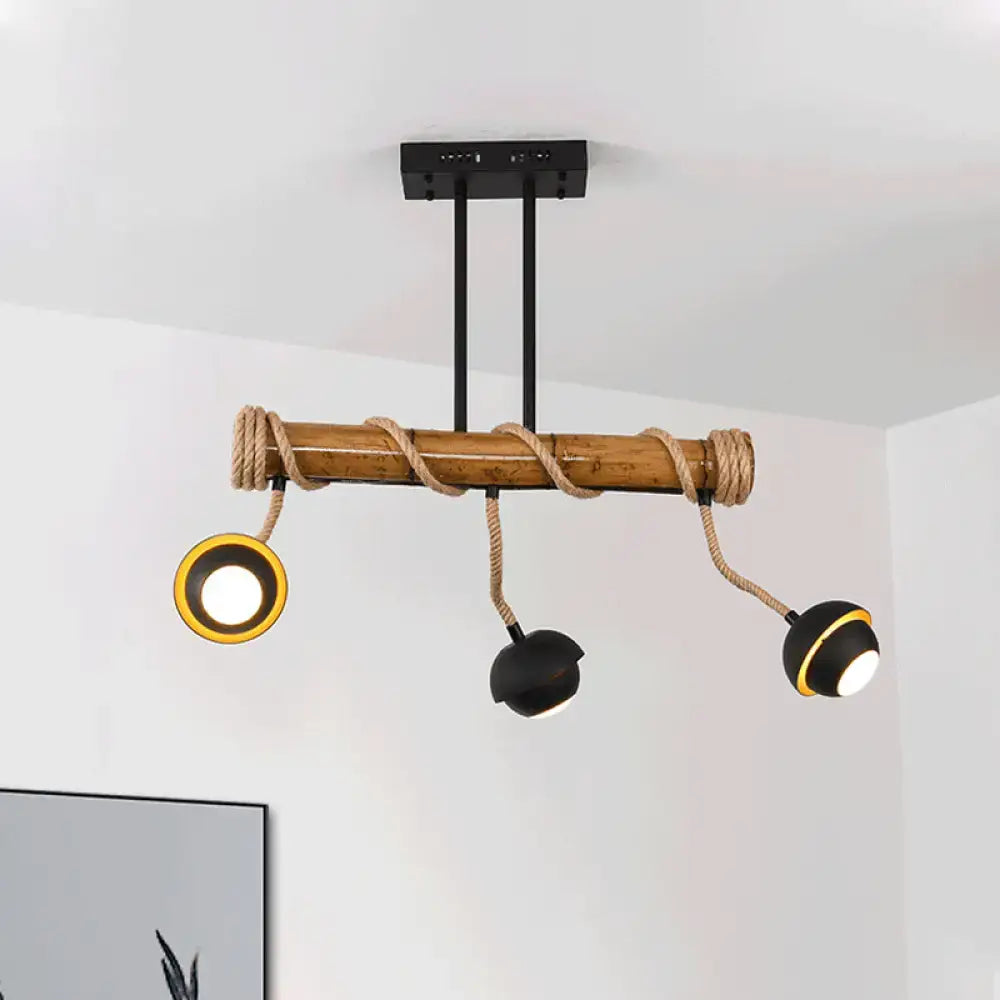 Rustic bamboo ceiling light fixture with black metal arms and rope accents in industrial linear island chandelier design