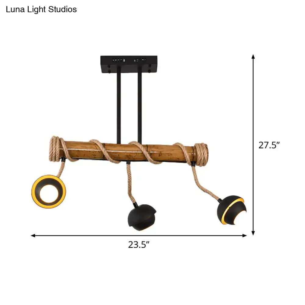 Rustic bamboo pendant light with black metal hardware and rope accents featuring three adjustable spotlight heads for industrial linear island use