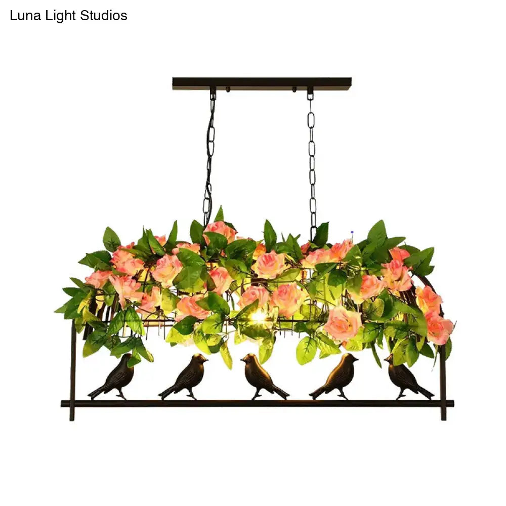 Black industrial metal birdcage hanging ceiling light with pink roses green leaves and five bird silhouettes