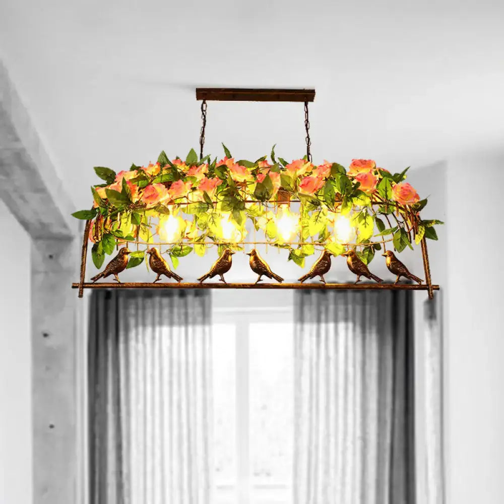 A rustic bronze industrial metal birdcage flower chandelier with artificial roses and birds as a hanging ceiling light