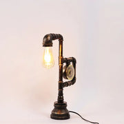 Decorbites industrial metal nightstand lamp with dark aged brass finish and exposed incandescent fluorescent bulb