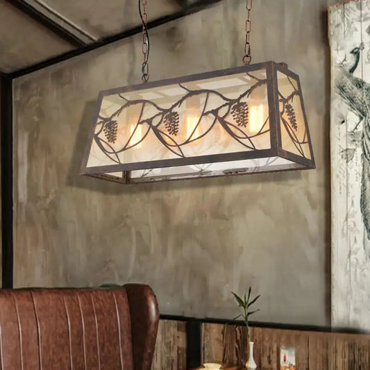 DecorBites™ industrial rectangular pendant light with bronze metal frame, frosted glass panels, and pinecone cutouts
