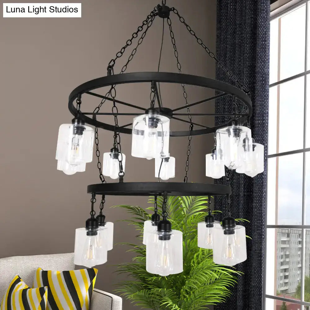 Black metal industrial pendant chandelier with clear glass shades and exposed filament bulbs by DecorBites