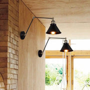 DecorBites™ industrial plug in wall sconce with black conical shade brass accents ideal for commercial space lighting