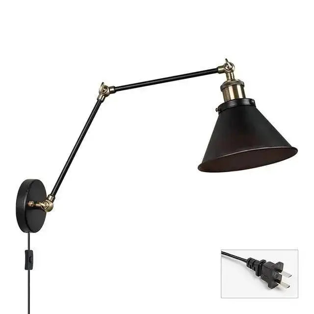Black industrial-style DecorBites™ wall sconce with adjustable arms, brass accents, and plug-in design for commercial space