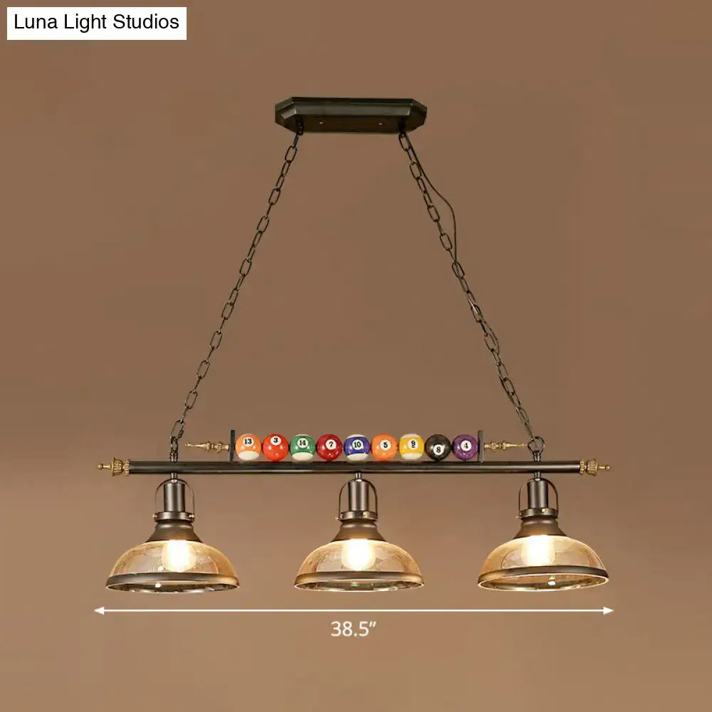 Industrial style billiard light pendant with dark metal frame brass accents and chain cord length for restaurant island