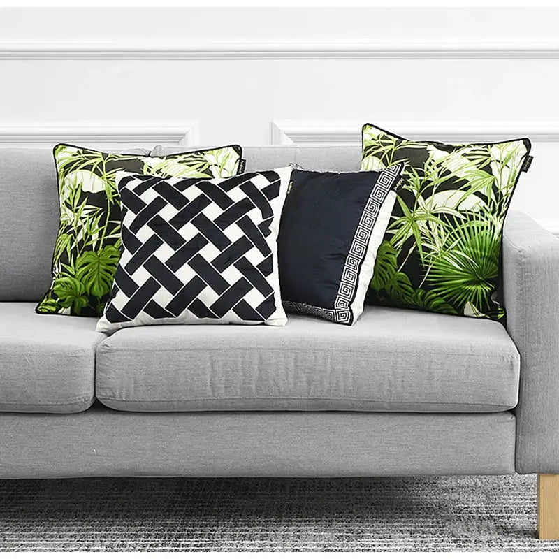 Three decorative throw pillows featuring decorbites intersecting geometric navy and white cushion cover with bold patterns